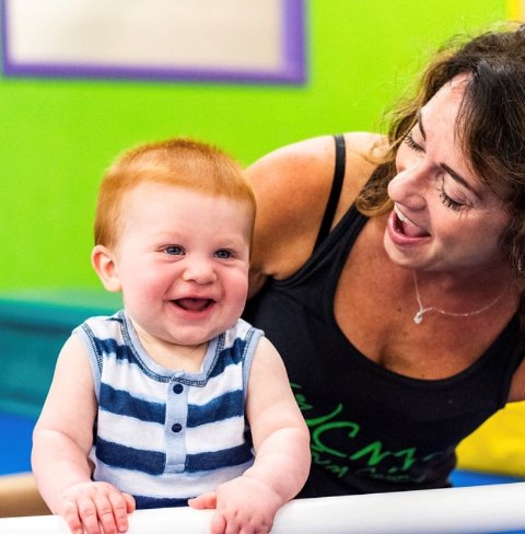 A Baby Gym class at CNY Gym Centre — a smiling baby at the bar with a parent
